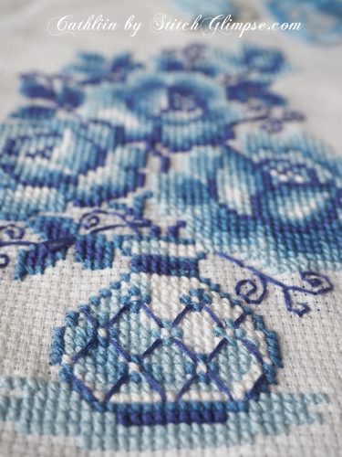 cross stitched vase with flowers in blue